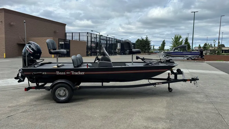 Slide: The Image of 2025 Tracker Bass Tracker Classic XL boat on trailer in parking lot. - 13