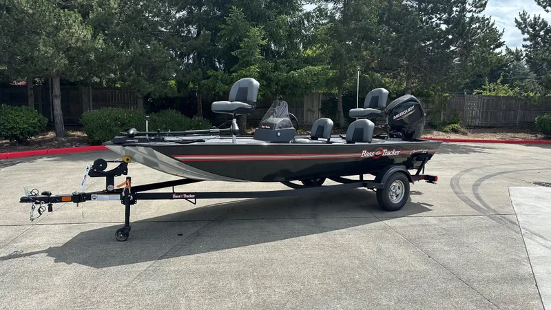 Slide: The Image of 2025 Tracker Bass Tracker Classic XL boat on trailer, parked outdoors. - 16