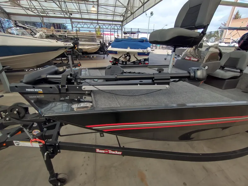 Slide: The Image of 2025 Tracker Bass Tracker Classic XL boat in showroom, featuring Minn Kota trolling motor. - 20