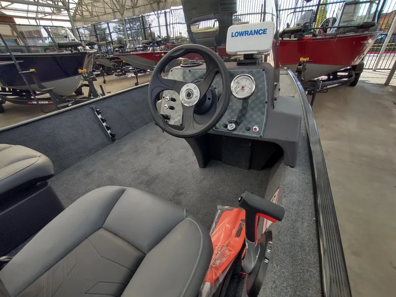 Slide: The Image of 2025 Tracker Bass Tracker Classic XL boat interior with steering wheel and Lowrance electronics. - 6