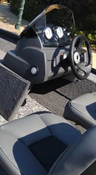 Slide: The Image of 2025 Tracker Pro Guide V-16 SC boat interior with steering wheel and dashboard. - 2