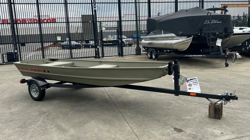 Slide: The Image of 2025 Tracker Grizzly 14 Jon boat on trailer in outdoor showroom. - 2