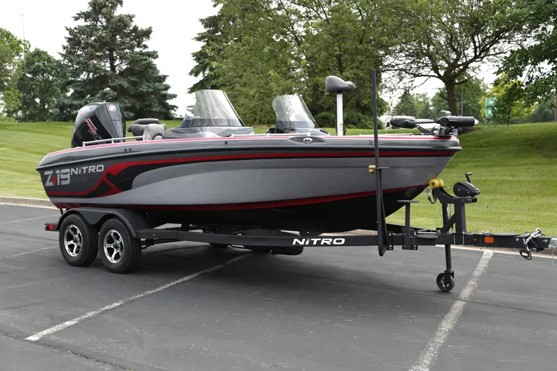 The Image of 2025 Nitro ZV19 boat on trailer in parking lot, side view. - 0