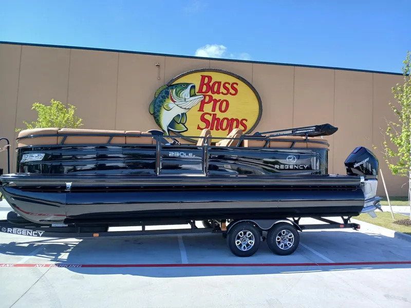 Slide: The Image of 2025 Regency 230 LE3 pontoon boat displayed at Bass Pro Shops. - 3