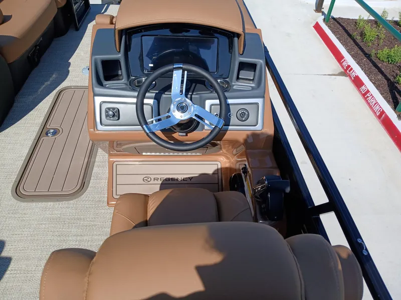 Slide: The Image of 2025 Regency 230 LE3 boat dashboard with steering wheel and control panel. - 7