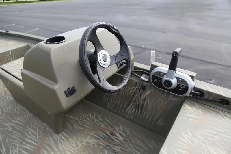 Slide: The Image of 2025 Tracker Grizzly 1648 SC boat steering console with control panel. - 4