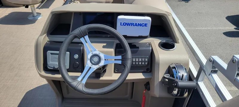 Slide: The Image of 2025 Sun Tracker Fishin' Barge 20 DLX dashboard with steering wheel and Lowrance navigation system. - 4