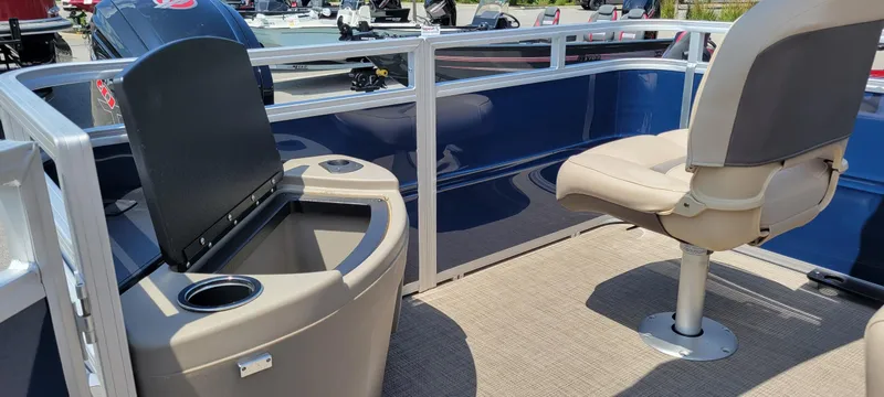 Slide: The Image of 2025 Sun Tracker Fishin' Barge 20 DLX interior with seating and storage. - 5