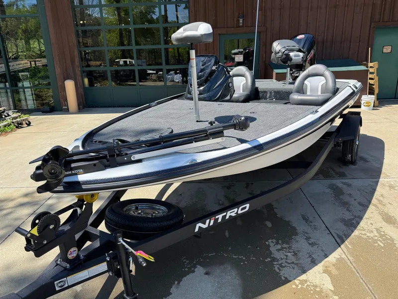 Slide: The Image of 2025 Nitro Z17 fishing boat on trailer, parked outdoors. - 2