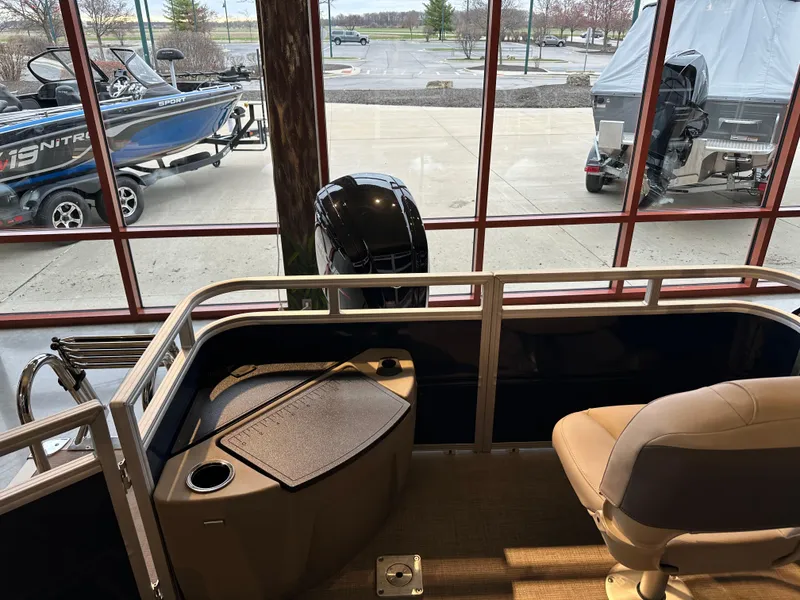 Slide: The Image of 2025 Sun Tracker Fishin' Barge 20 DLX interior with seating and motor view. - 4