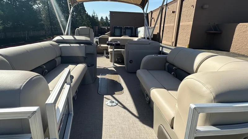 Slide: The Image of 2025 Sun Tracker SportFish 22 XP3 pontoon boat interior with beige seating and spacious layout. - 4