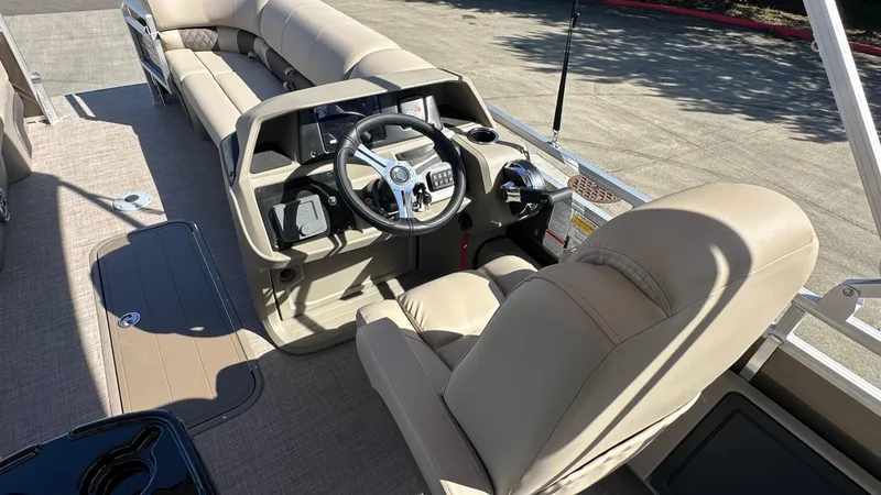Slide: The Image of 2025 Sun Tracker SportFish 22 XP3 boat interior with steering wheel and seating. - 5