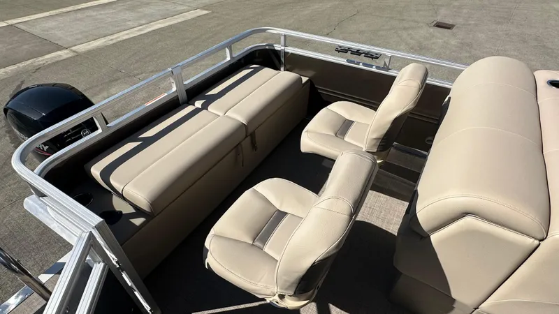 Slide: The Image of 2025 Sun Tracker SportFish 22 XP3 boat interior with beige seating and sleek design. - 6