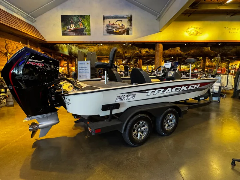 The Image of 2025 Tracker Savage 215 boat displayed indoors with Mercury Pro XS engine. - 0
