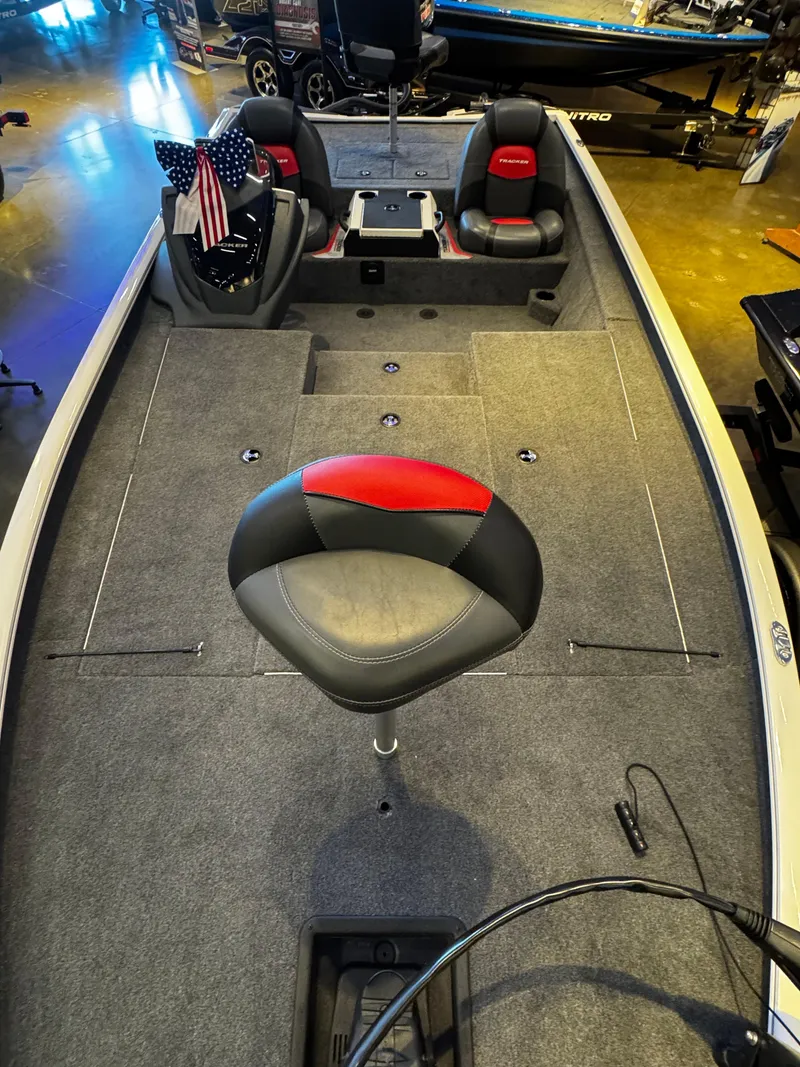 Slide: The Image of 2025 Tracker Savage 215 boat interior with seating and carpeted deck. - 2