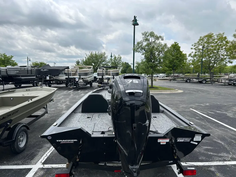 Slide: The Image of 2025 Tracker Pro Team 175 boat in parking lot, overcast sky, surrounded by trees and trailers. - 4