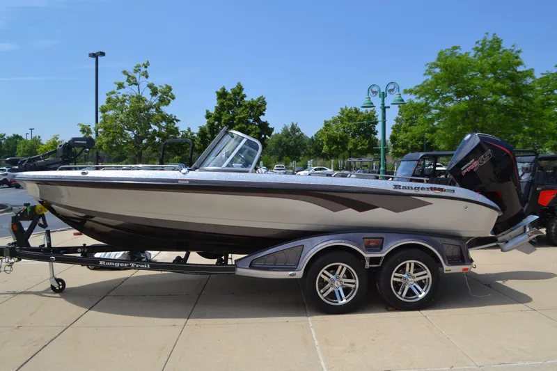 The Image of 2025 Ranger 620FS Cup Equipped boat on trailer, parked outdoors. - 0