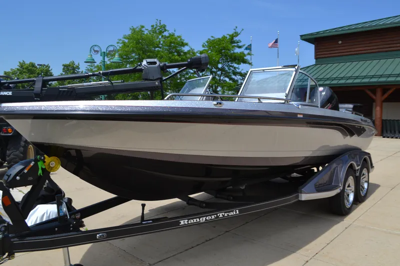 Slide: The Image of 2025 Ranger 620FS Cup Equipped boat on trailer, parked outdoors near a building. - 1