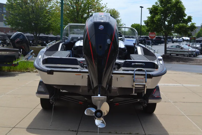 Slide: The Image of 2025 Ranger 620FS Cup Equipped boat, rear view with outboard motor, parked outdoors. - 2