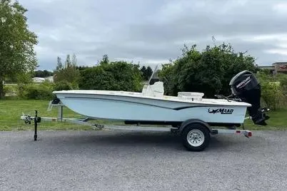 Slide: The Image of 2025 Mako Pro Skiff 15 CC boat on trailer, parked outdoors. - 0