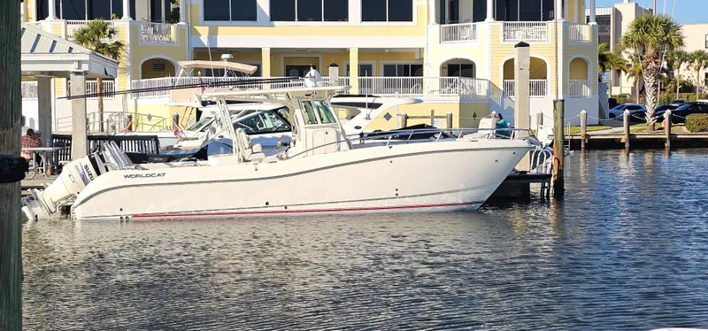 Slide: The Image of 2016 World Cat 320 boat docked near waterfront property. - 1