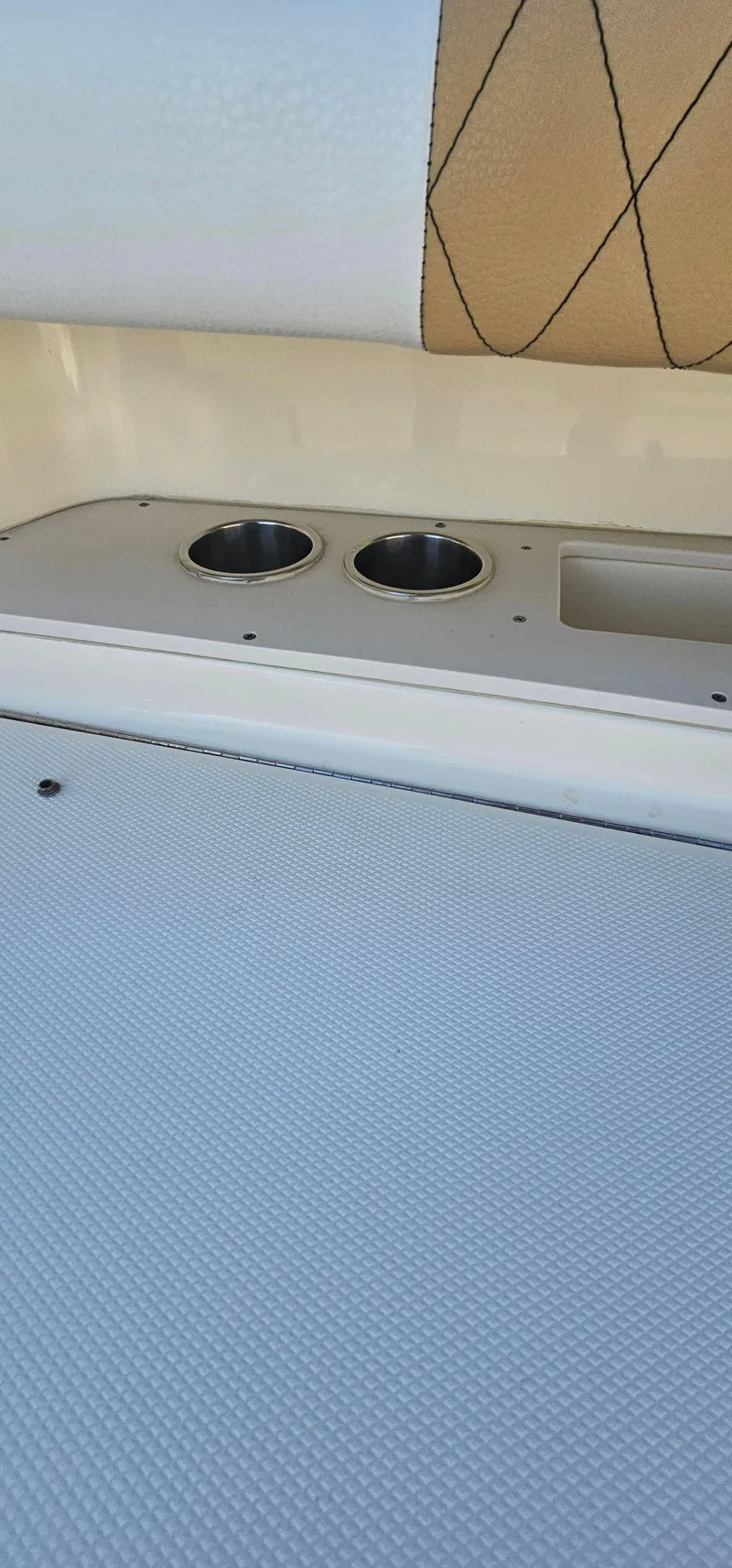 Slide: The Image of 2016 World Cat 320 boat interior with cup holders and cushioned seating. - 20