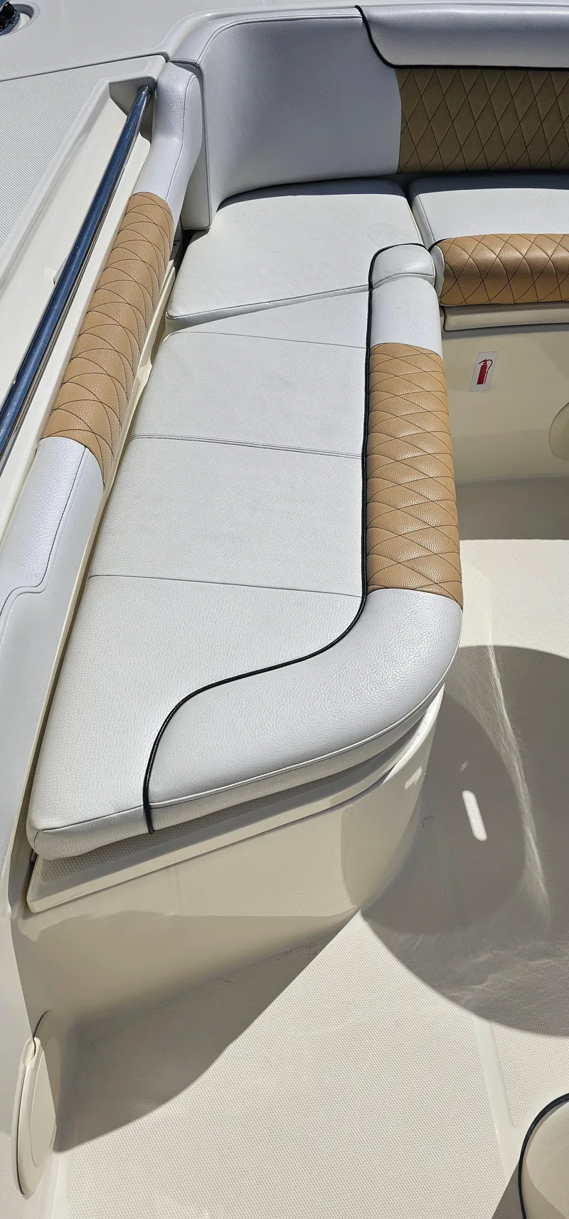 Slide: The Image of 2016 World Cat 320 boat interior with cushioned seating and tan accents. - 24