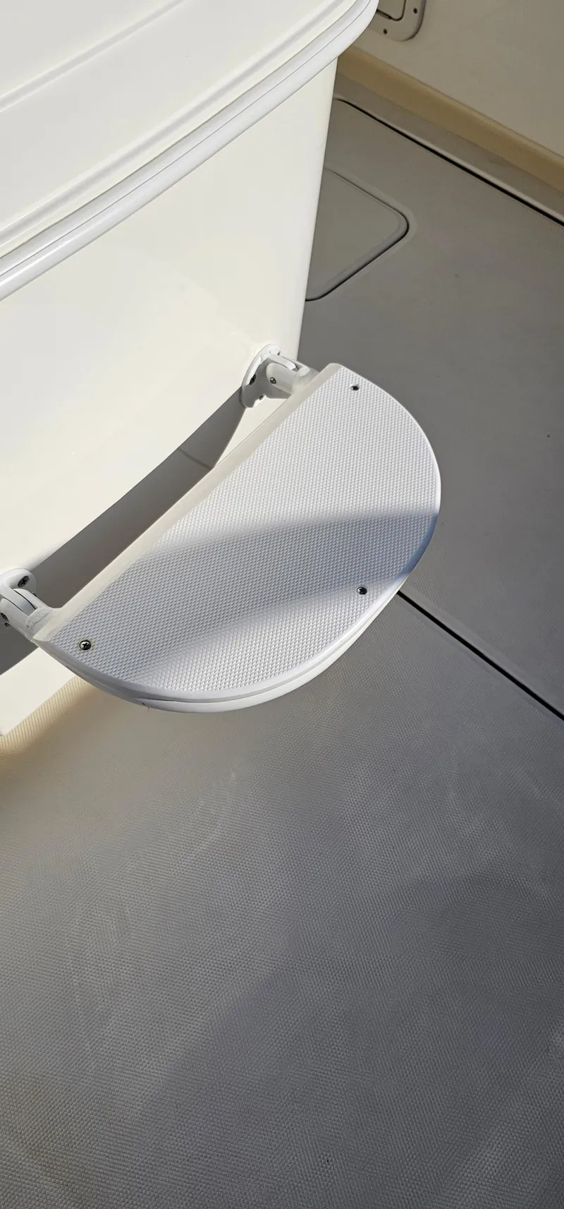 Slide: The Image of 2016 World Cat 320 boat step detail, featuring a textured, foldable design for easy access. - 28