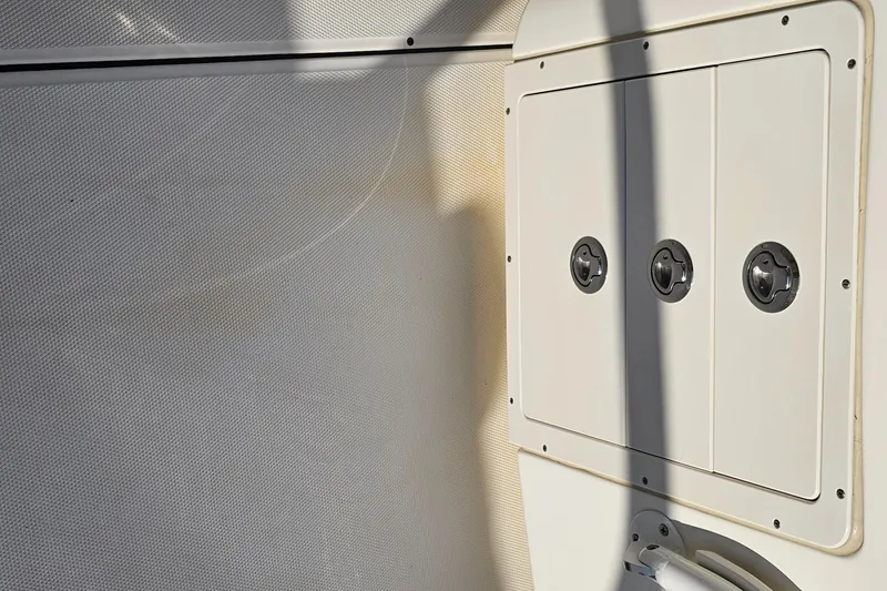 Slide: The Image of Interior view of a 2016 World Cat 320 boat, featuring a white panel with three circular fixtures. - 30