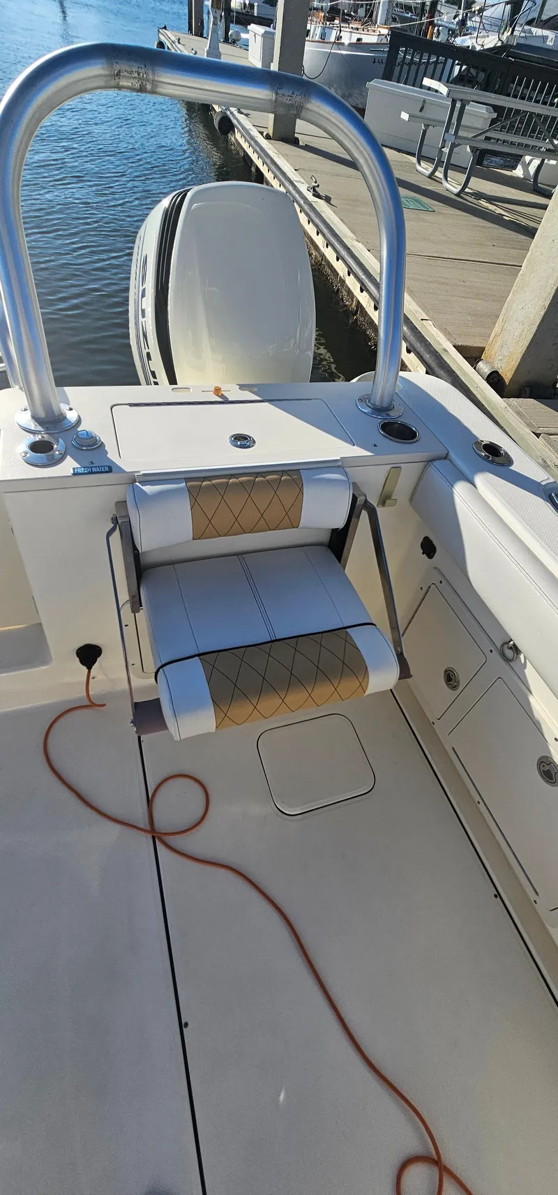 Slide: The Image of 2016 World Cat 320 boat interior with seating and railing at dockside. - 31