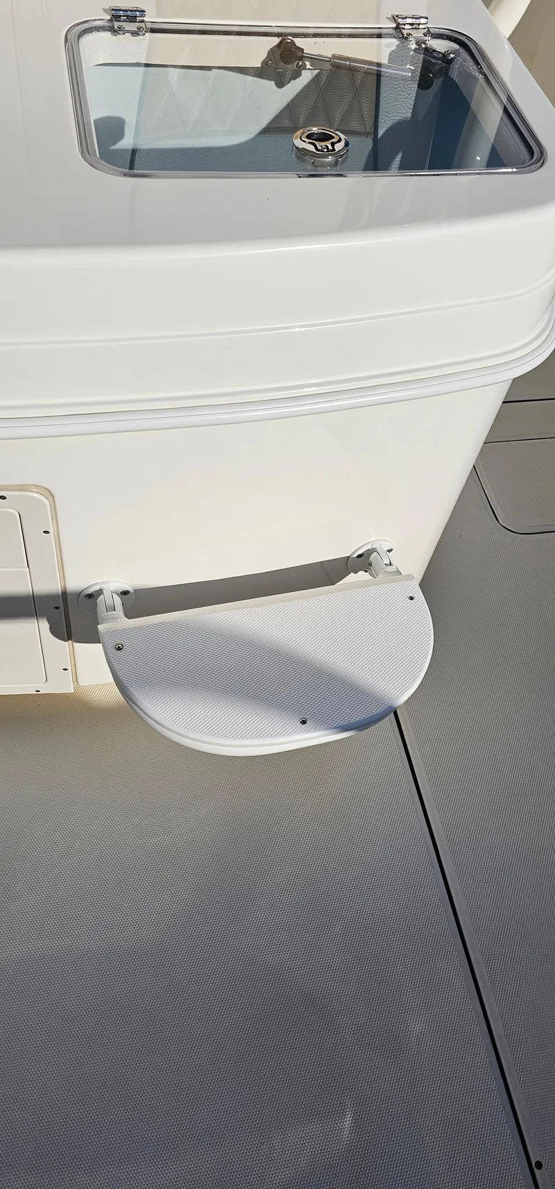 Slide: The Image of 2016 World Cat 320 boat deck with step and storage compartment. - 34