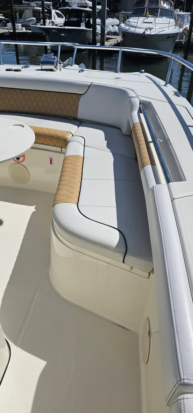 Slide: The Image of 2016 World Cat 320 boat with cushioned seating and table, docked at marina. - 37