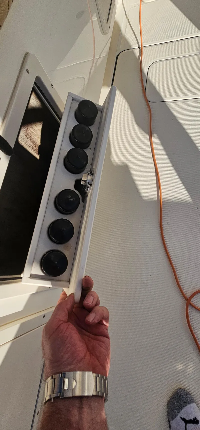 Slide: The Image of 2016 World Cat 320 boat with open storage compartment and visible control knobs. - 38