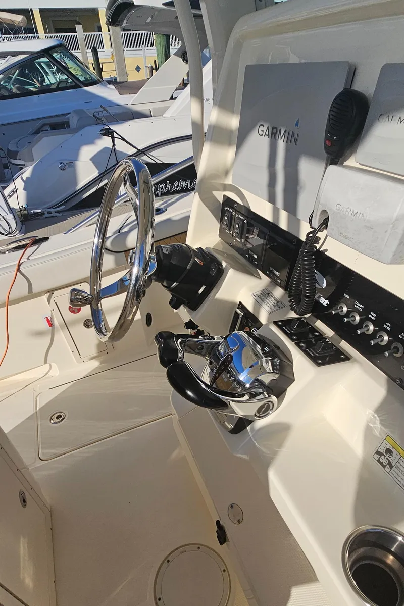 Slide: The Image of 2016 World Cat 320 boat helm with Garmin navigation and control panel. - 40