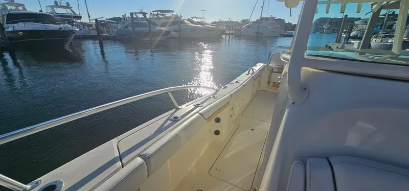 Slide: The Image of 2016 World Cat 320 boat docked in marina, sun reflecting on water. - 5