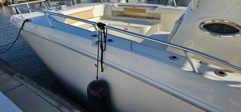 Slide: The Image of 2016 World Cat 320 boat docked, featuring sleek design and spacious seating area. - 7