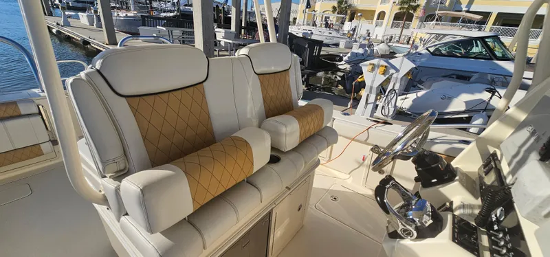 Slide: The Image of Luxurious seating on a 2016 World Cat 320 boat, featuring plush, tan and white upholstery. - 9