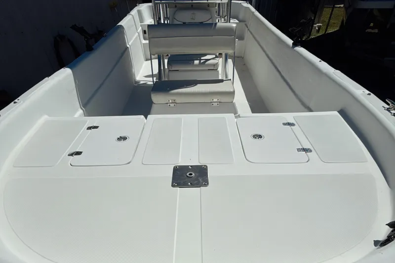 Slide: The Image of 2008 Carolina Skiff 238 DLV boat interior with spacious seating and storage compartments. - 11