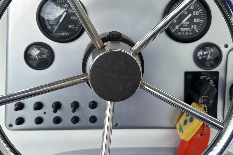 Slide: The Image of Steering wheel and dashboard of a 2008 Carolina Skiff 238 DLV boat. - 13