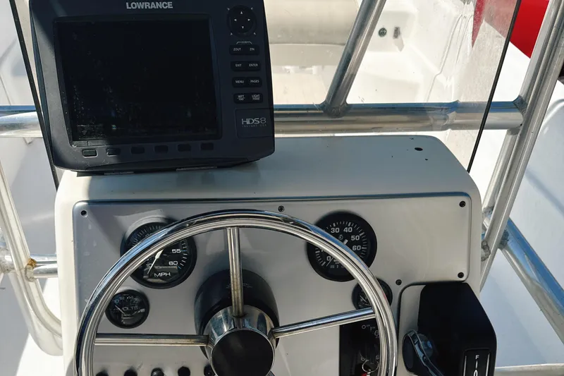 Slide: The Image of Console of 2008 Carolina Skiff 238 DLV with Lowrance navigation system and steering wheel. - 14
