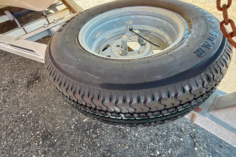 Slide: The Image of Spare tire mounted on a trailer for a 2008 Carolina Skiff 238 DLV boat. - 17