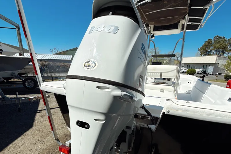 Slide: The Image of 2008 Carolina Skiff 238 DLV boat with Suzuki 140 outboard motor, parked outdoors. - 4