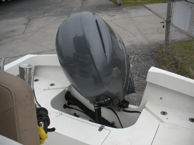 Slide: The Image of 2017 Parker 2100 Special Edition boat with outboard motor in a parking area. - 16