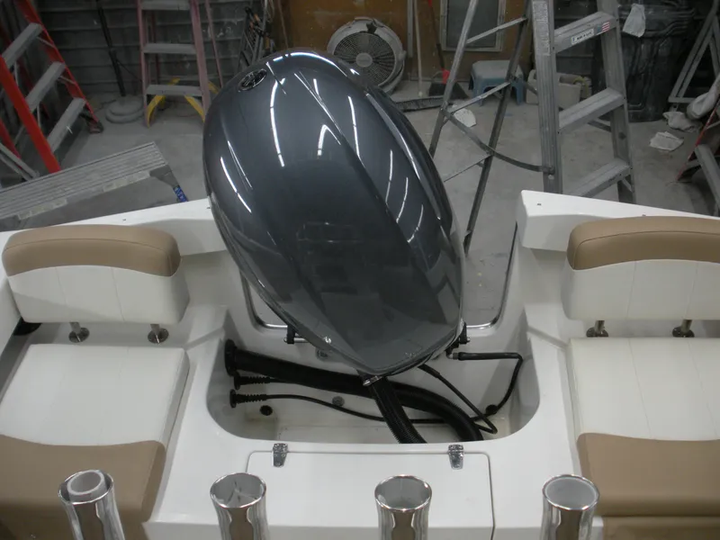 Slide: The Image of 2017 Parker 2100 Special Edition boat with outboard motor in workshop setting. - 17