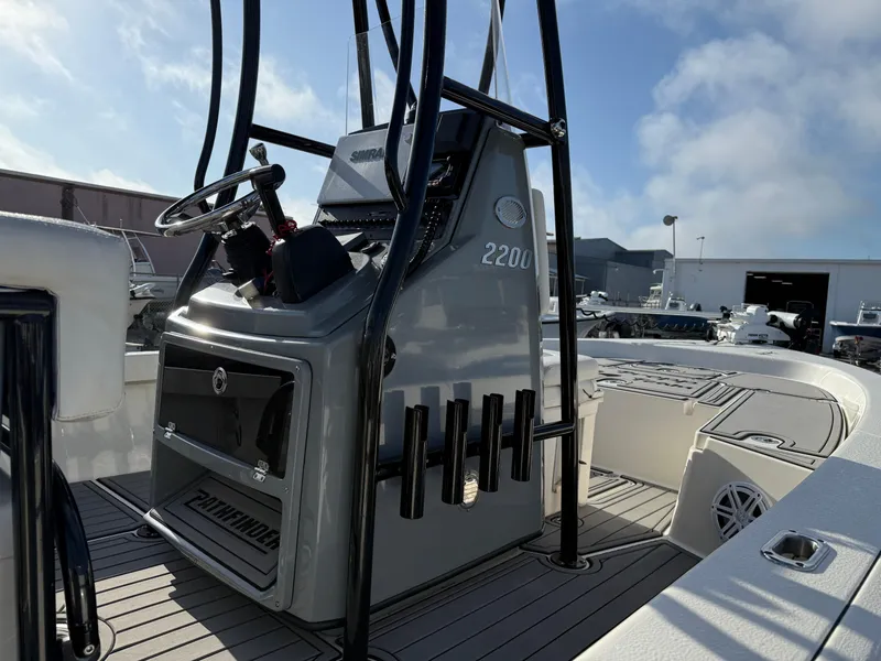 Slide: The Image of Pathfinder 2200 Tournament boat, 2020 model, featuring a sleek console and rod holders. - 11