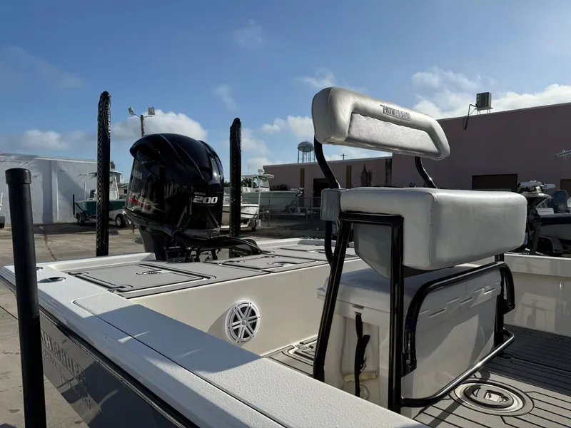 Slide: The Image of 2020 Pathfinder 2200 Tournament boat with motor and seating, docked under clear sky. - 12