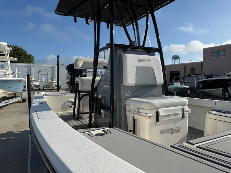 Slide: The Image of 2020 Pathfinder 2200 Tournament boat with T-top and seating, docked under clear skies. - 13