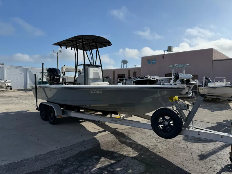 Slide: The Image of 2020 Pathfinder 2200 Tournament boat on trailer, parked outdoors under clear sky. - 15