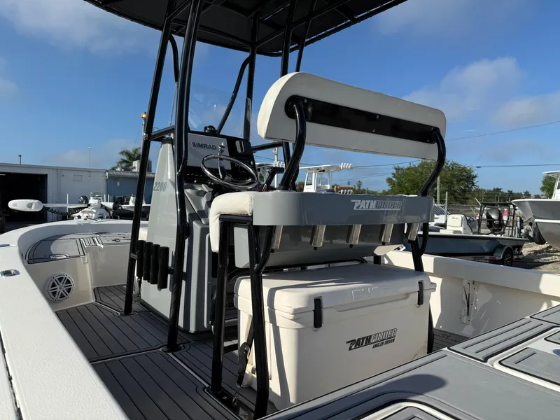 Slide: The Image of 2020 Pathfinder 2200 Tournament boat interior with seating and console, featuring a cooler. - 6