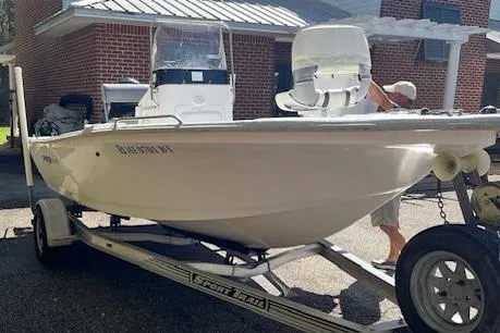 Slide: The Image of 2009 Pro-Line 17 CC boat on trailer, parked near a brick building. - 3